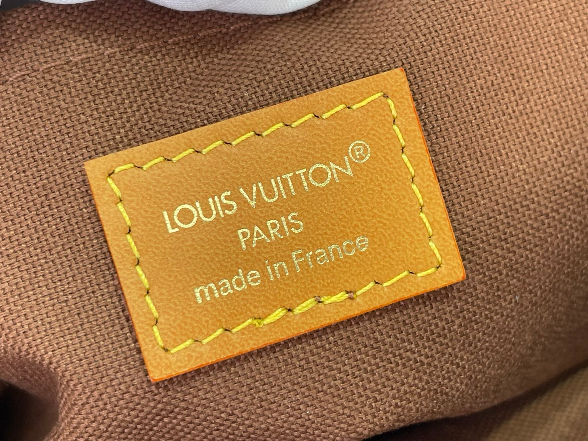 Louis Vuitton Paris label on brown textile bag lining, made in France