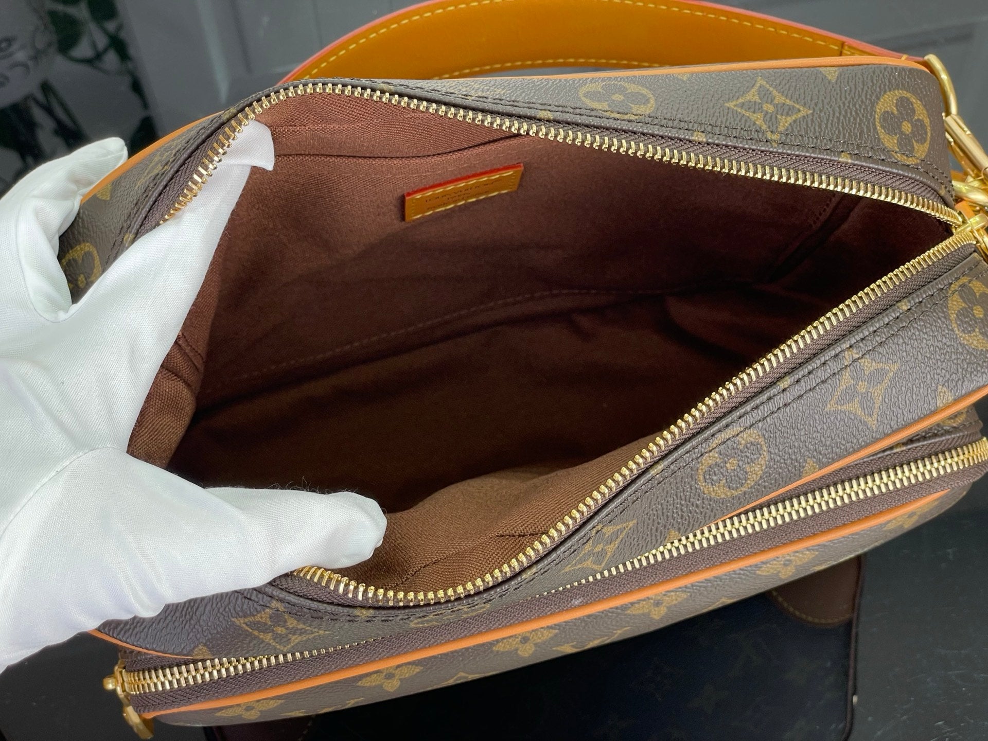 Louis Vuitton monogram bag interior lining with zip opening and tan leather trim