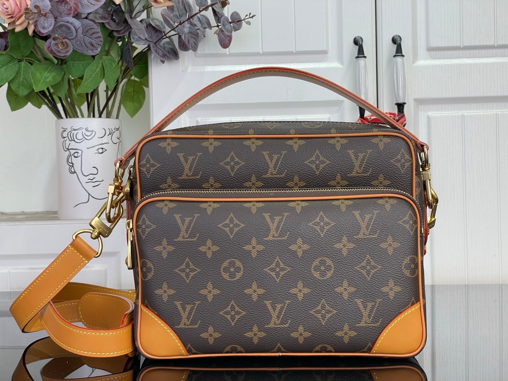 Louis Vuitton monogram crossbody bag with tan trim and gold-tone hardware