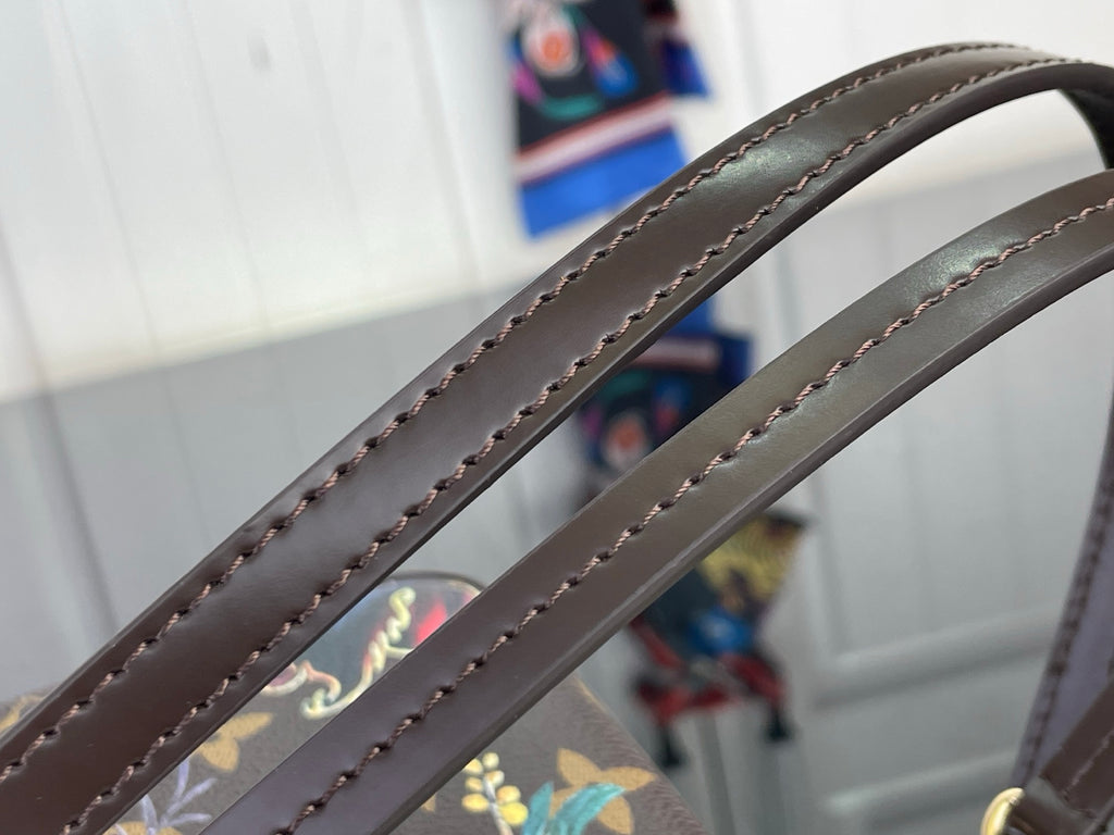 Dark leather crossbody strap with decorative edge stitching