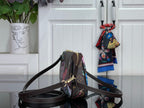 Printed crossbody bag with adjustable shoulder strap and gold zipper pull