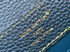 Blue pebble-grain leather with embossed Louis Vuitton Paris text and yellow edge stitching