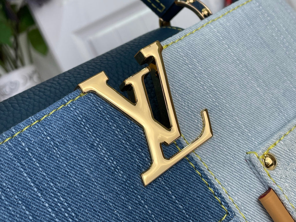 Louis Vuitton LV gold logo on blue denim-look bag front with contrast stitching