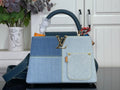 Louis Vuitton denim-look handbag with blue handles and gold LV emblem, strap