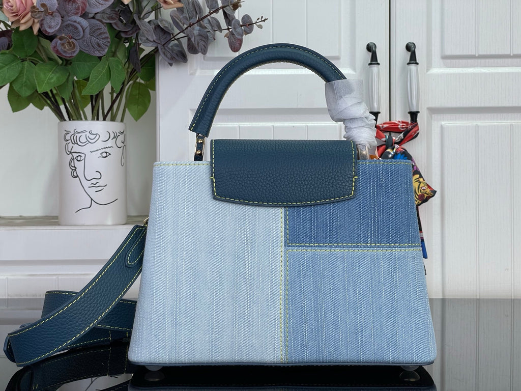 Louis Vuitton denim-look handbag with top handle and front flap pocket, blue