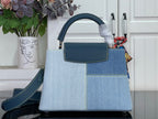 Louis Vuitton denim-look handbag with top handle and front flap pocket, blue