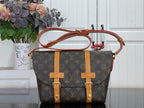 Louis Vuitton monogram crossbody bag with tan leather panels and red strap handles