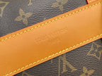 Tan leather strap with stitched edge and embossed wordmark reading Louis Vuitton