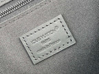 Louis Vuitton bag close-up of stitched logo label reading LOUIS VUITTON PARIS, made in France