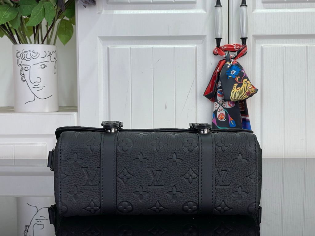 Louis Vuitton satchel bag in dark navy with front buckles and wide top handles