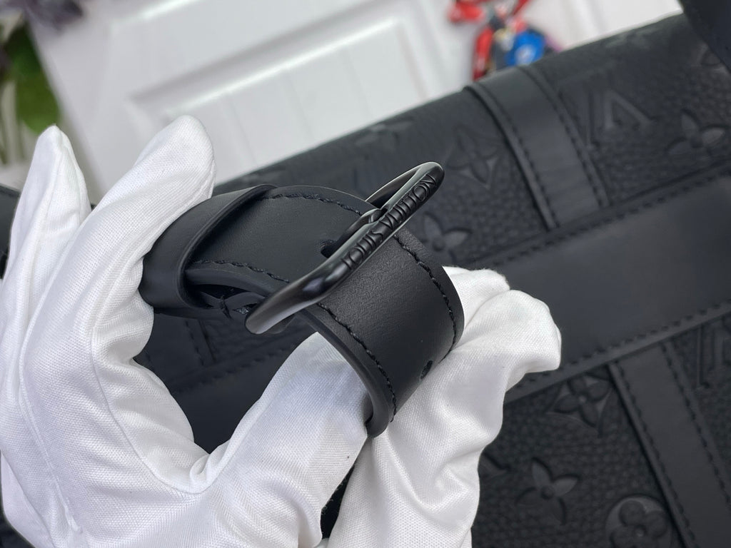 Louis Vuitton monogram bag close-up of dark strap and button closure on leather