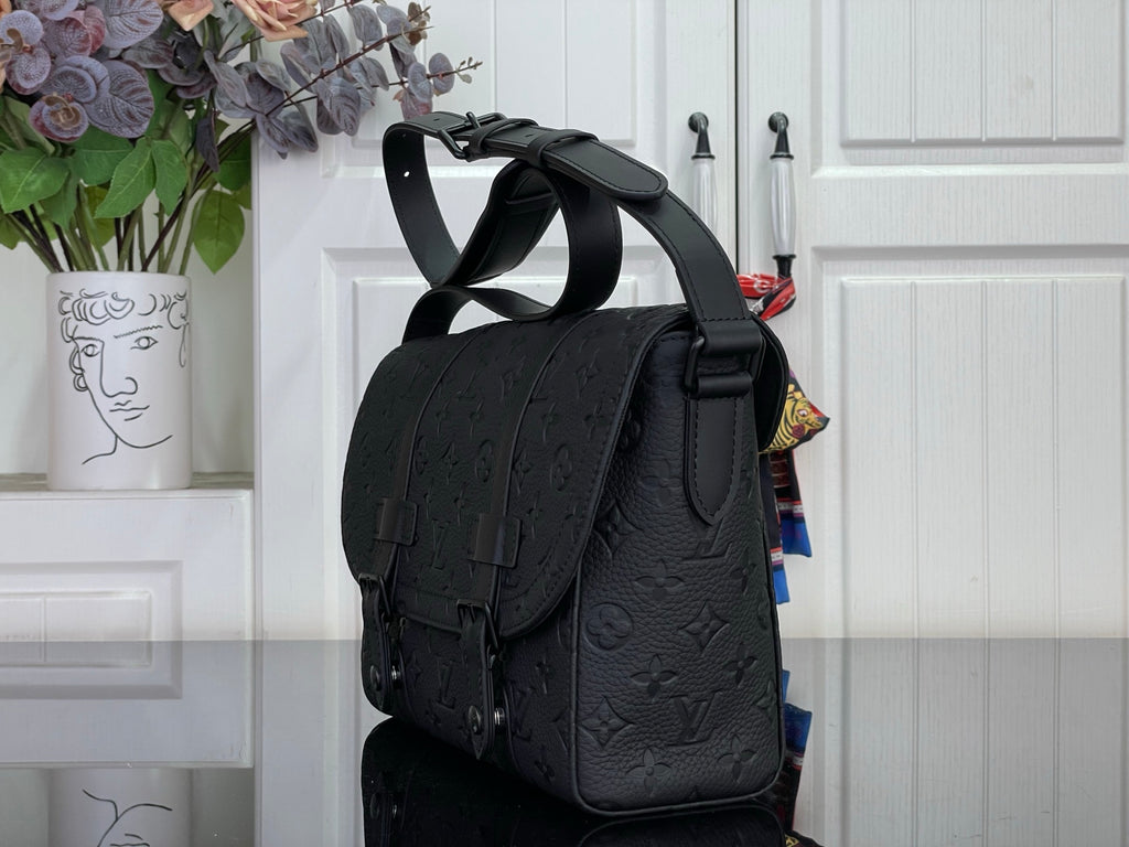 Louis Vuitton crossbody bag in dark navy with flap pocket and adjustable strap