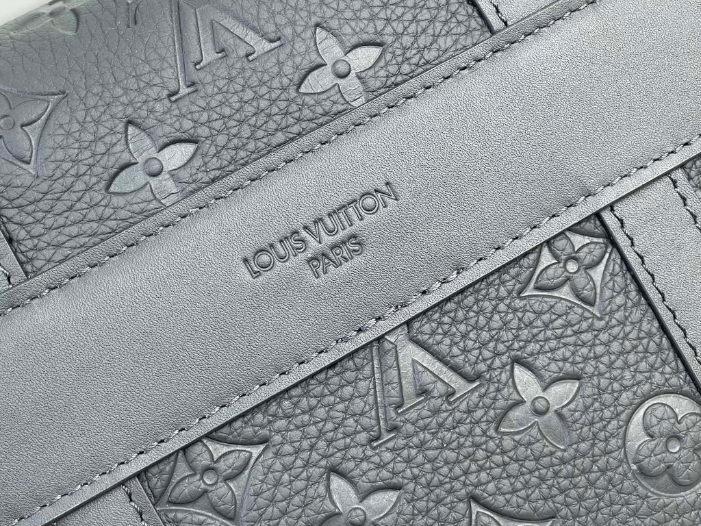 Louis Vuitton bag close-up of gray monogram lining with stitched interior panel