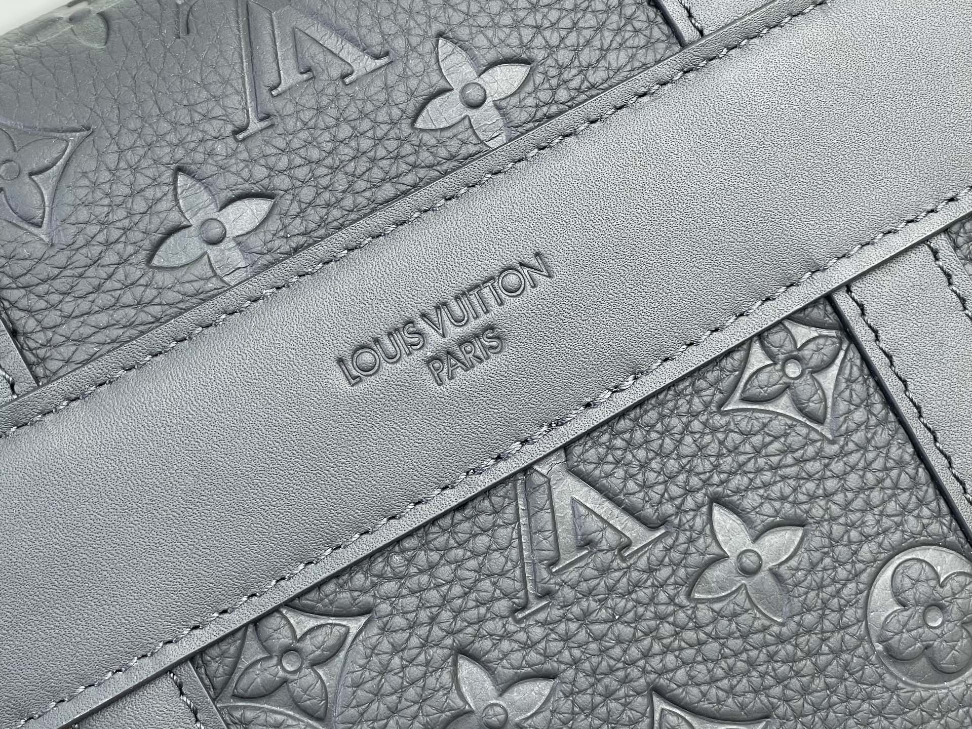 Louis Vuitton bag close-up of gray monogram lining with stitched interior panel