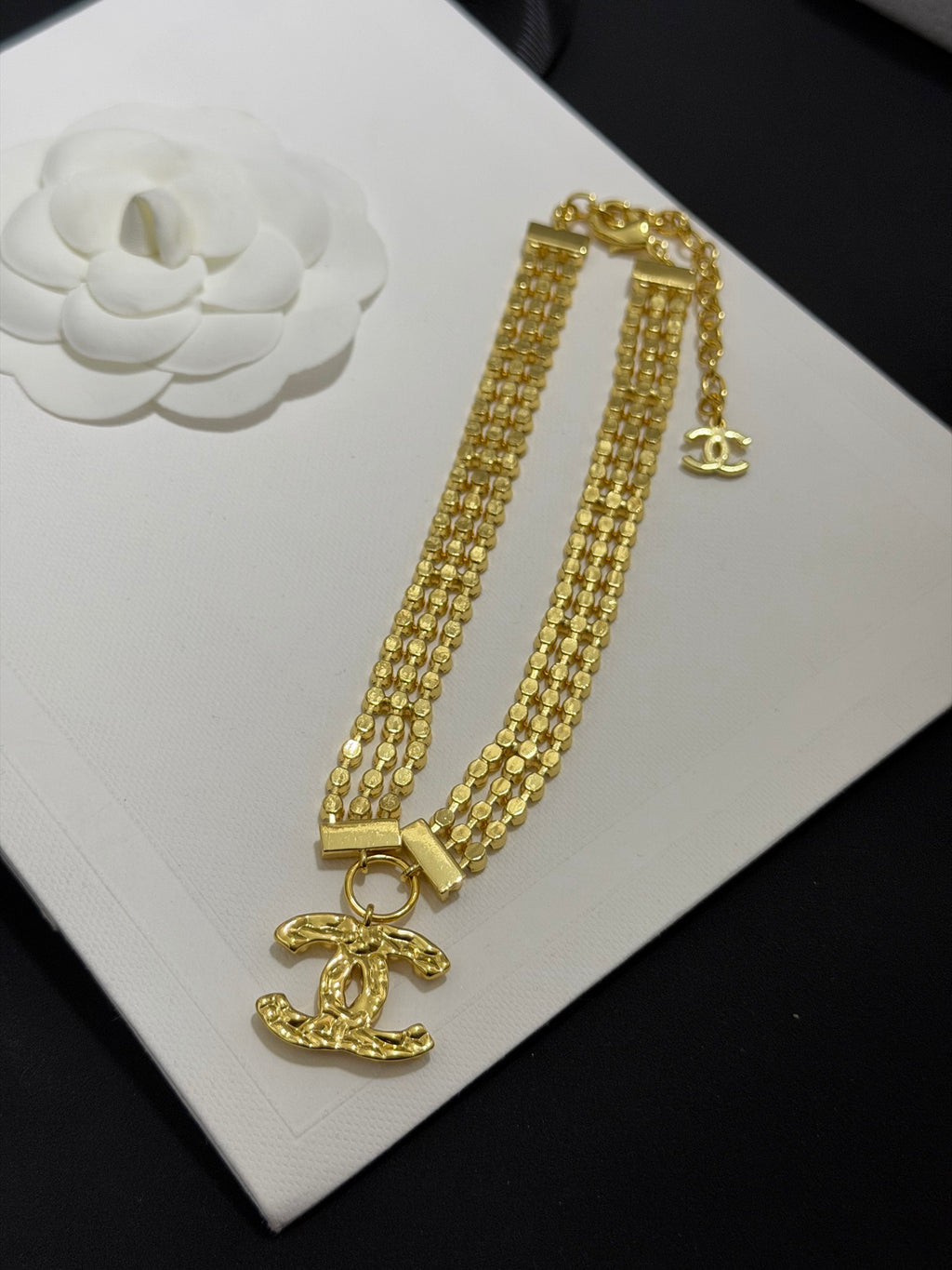 Gold-tone rhinestone double-strand necklace with CC clasp and dangling charm