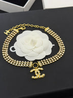 Gold-tone rhinestone choker necklace with CC bow pendant and double chain