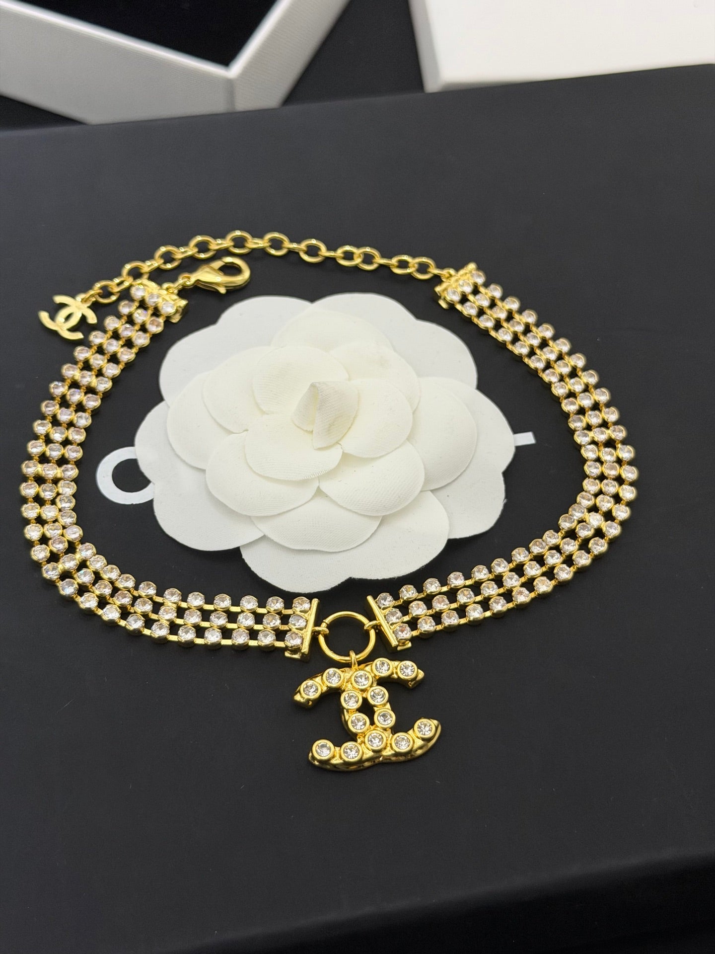 Gold-tone rhinestone choker necklace with CC bow pendant and double chain
