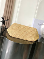 Woven straw shoulder bag with curved top flap and smooth woven texture