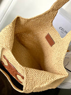 Woven straw tote bag interior with brown leather square logo patch