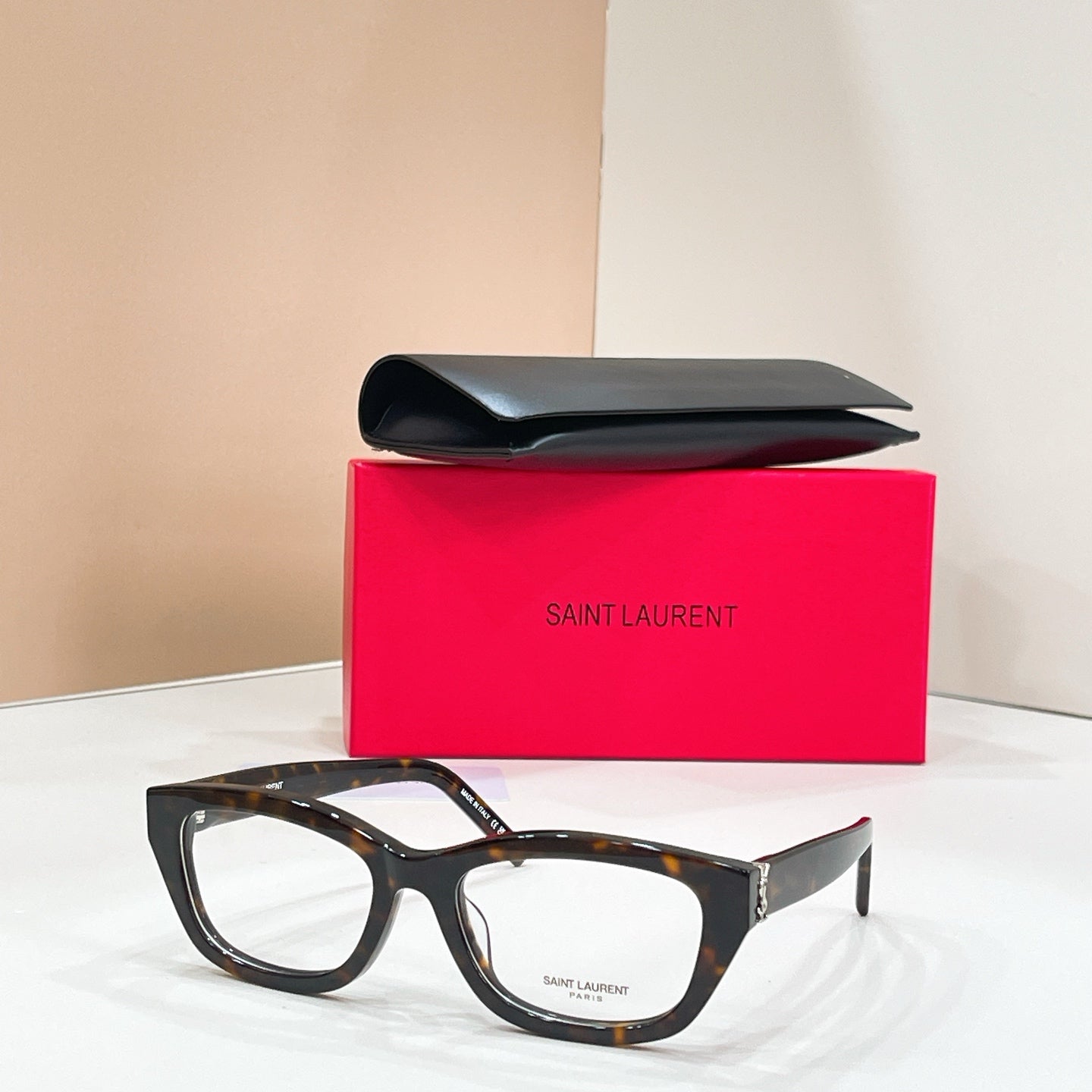 Tortoiseshell sunglasses with dark lenses and gold-tone hinge details, front angle