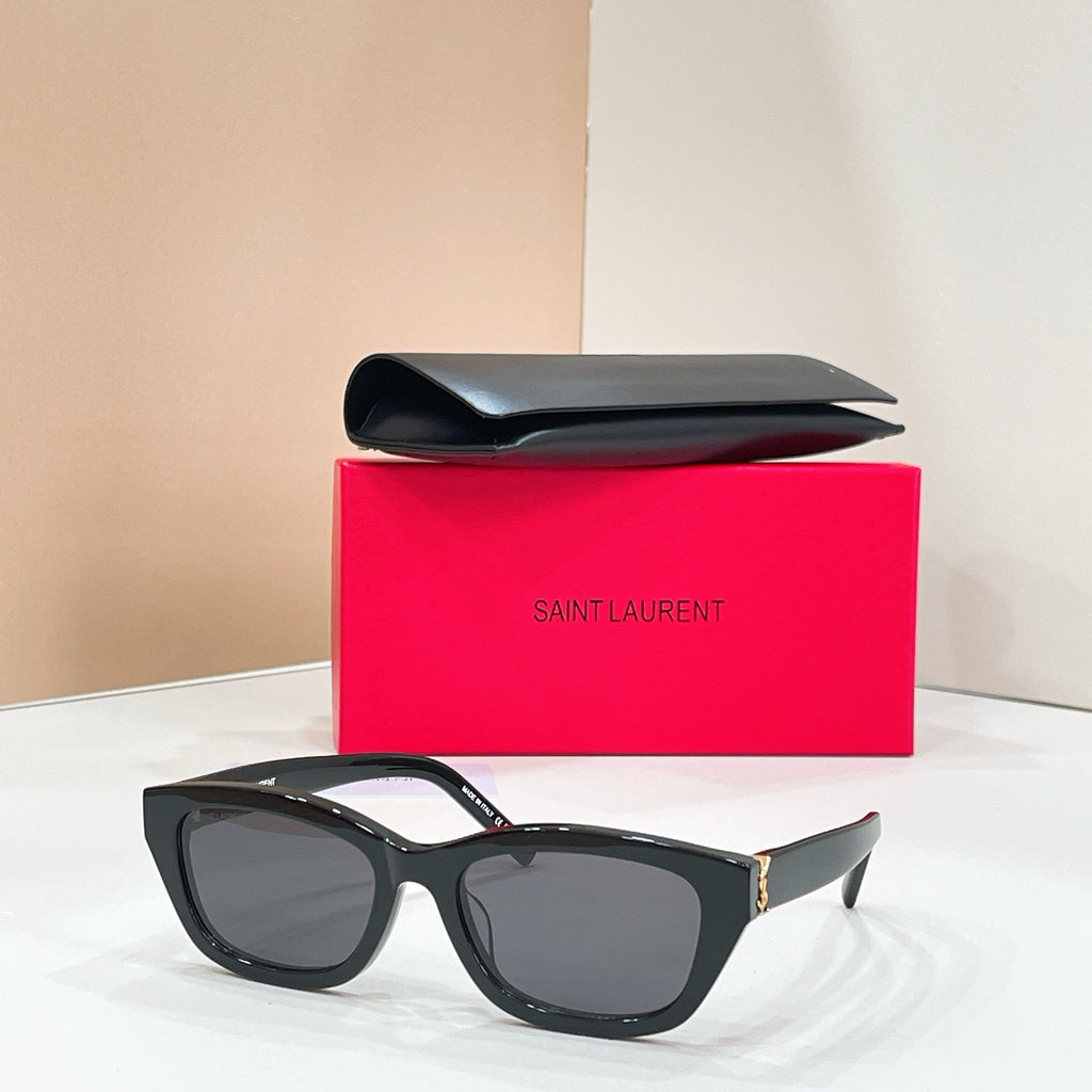 Black sunglasses with dark lenses and gold-tone hinge accents on the temples