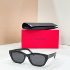 Black sunglasses with dark lenses and gold-tone hinge accents on the temples