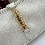 Gucci white leather bag close-up of gold-tone lock hardware and stitching