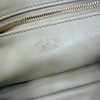 Gucci white leather bag close-up of 'Made in Italy' stamp on zipper panel