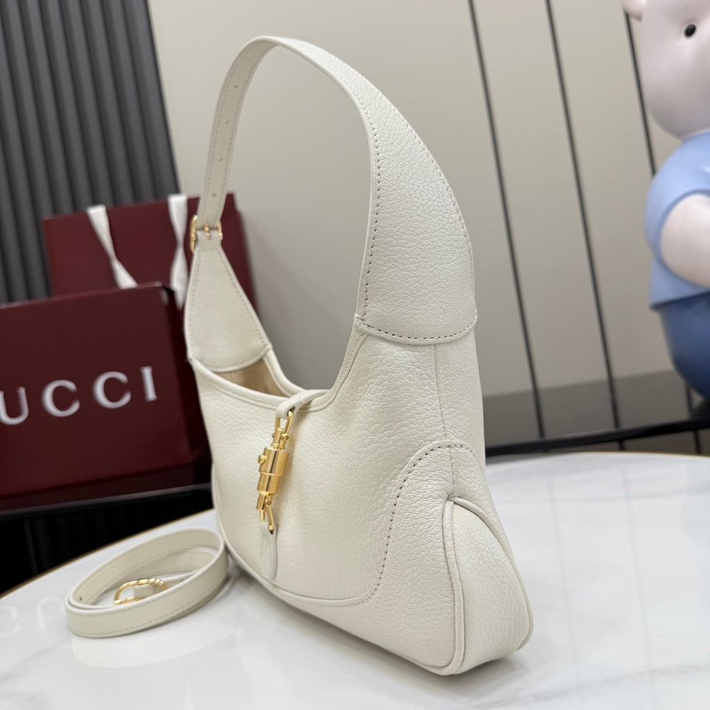Gucci white leather hobo bag angled view with top handle and gold-tone zipper pull