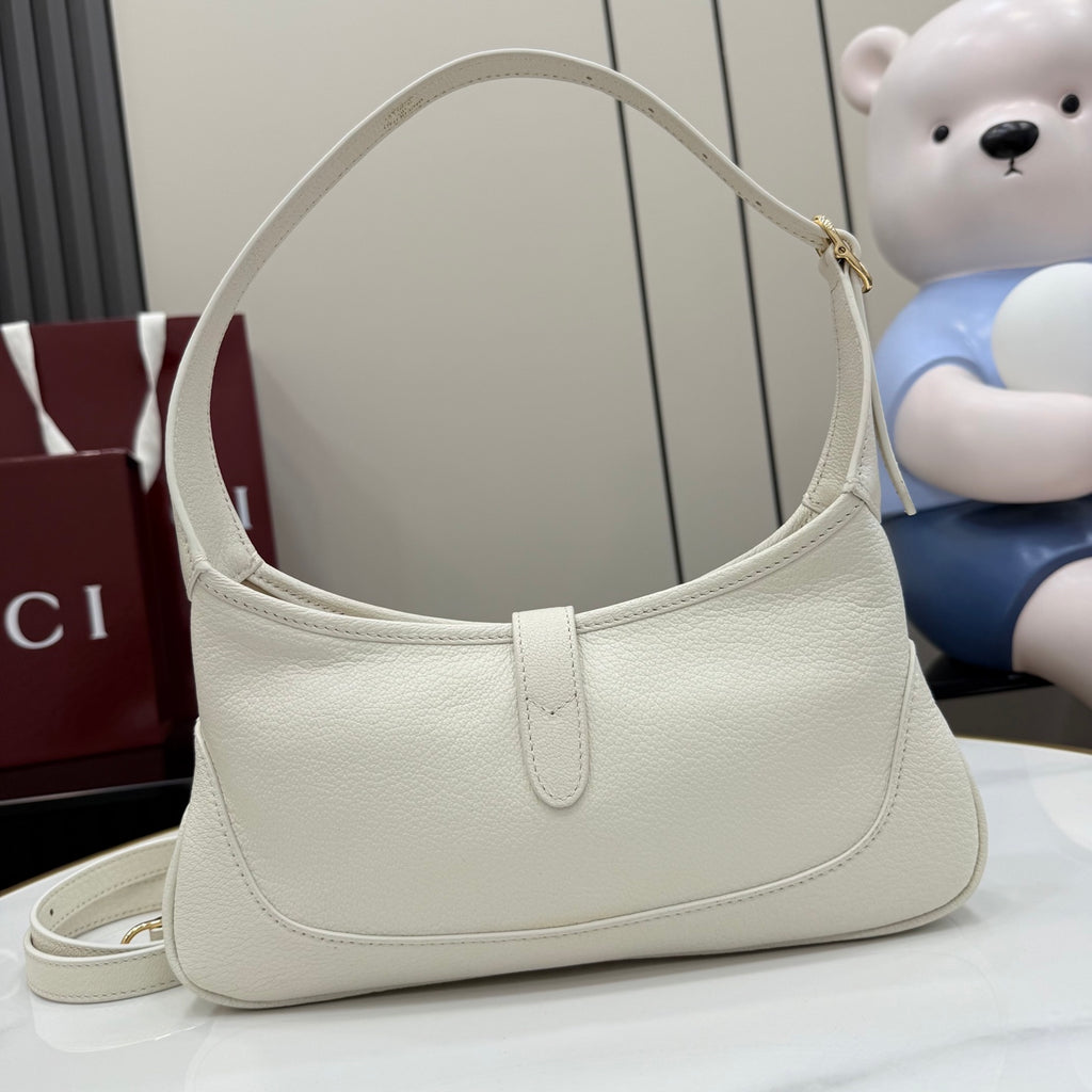 Gucci white leather hobo bag with curved top handle and gold-tone zipper pull