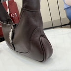 Gucci leather shoulder bag with adjustable strap and silver-toned hardware, dark