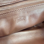 Leather hobo bag interior stamp and zipper seam close-up with “Gucci” lettering