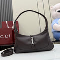 Dark leather hobo bag with curved handle and central silver-tone clasp hardware