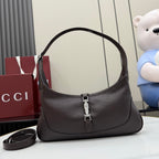 Dark leather hobo bag with curved handle and central silver-tone clasp hardware