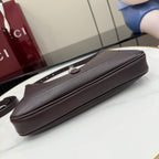 Dark leather hobo bag bottom and side profile with slim zippered edge