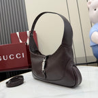 Dark leather hobo bag angled view with curved handle and central clasp