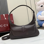 Dark leather hobo bag front view with rounded opening and curved top handle