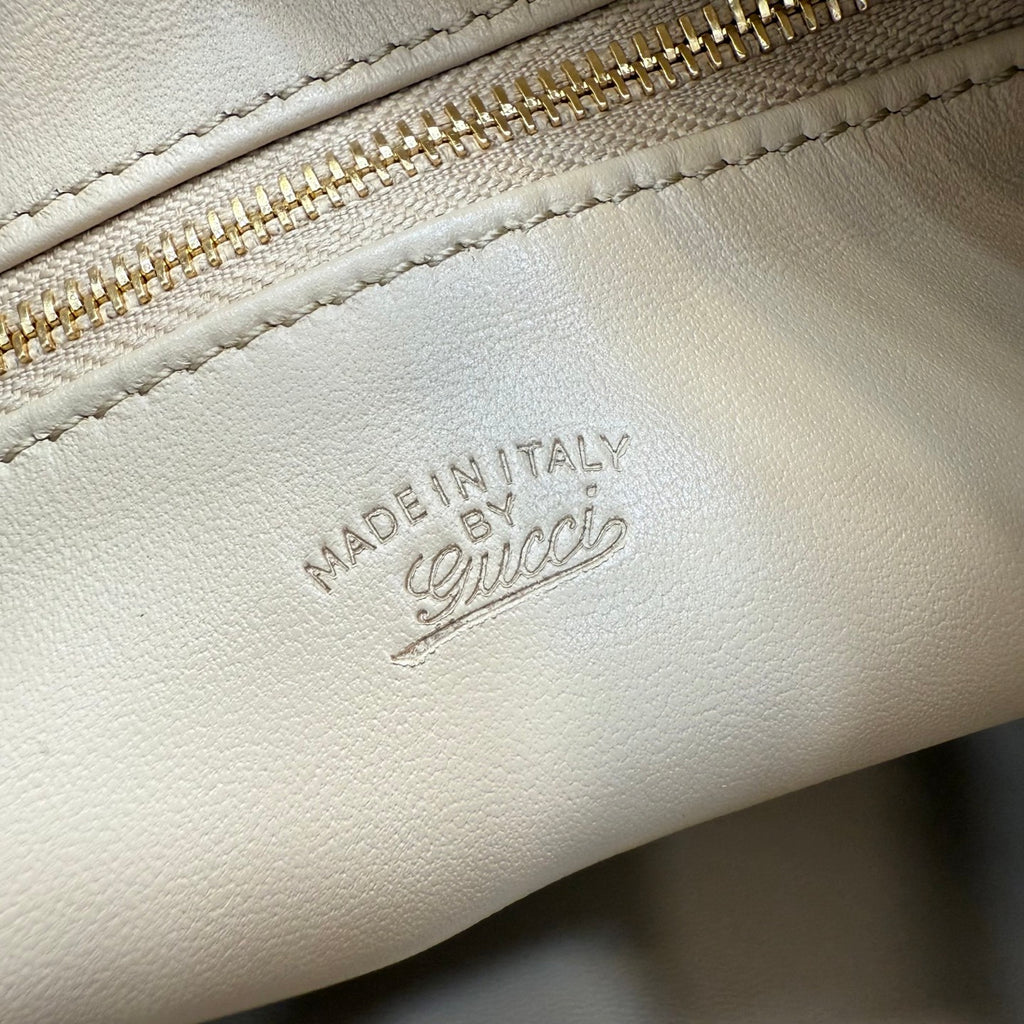 White leather bag with 'MADE IN ITALY' embossed stamp