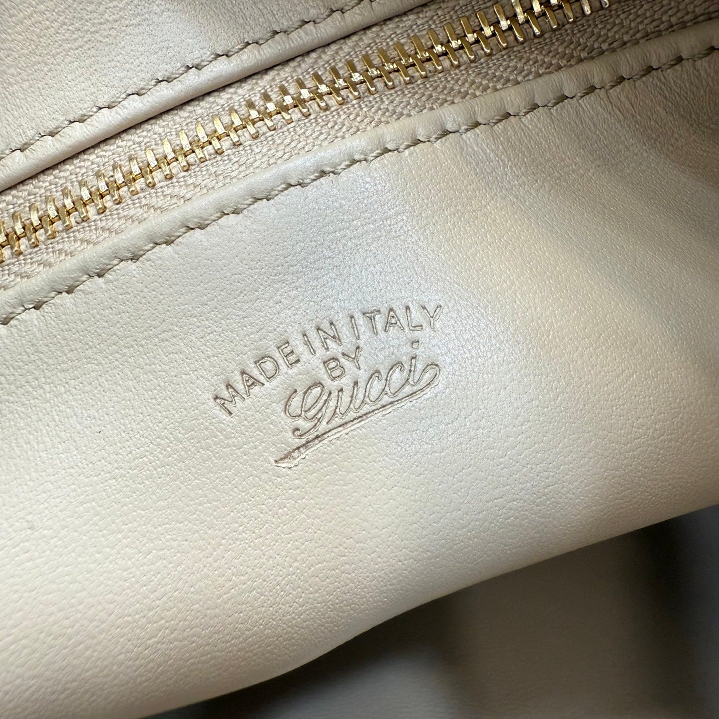 White leather bag with 'MADE IN ITALY' embossed stamp