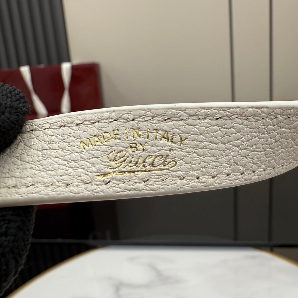 White leather strap with 'MADE IN ITALY' and script logo