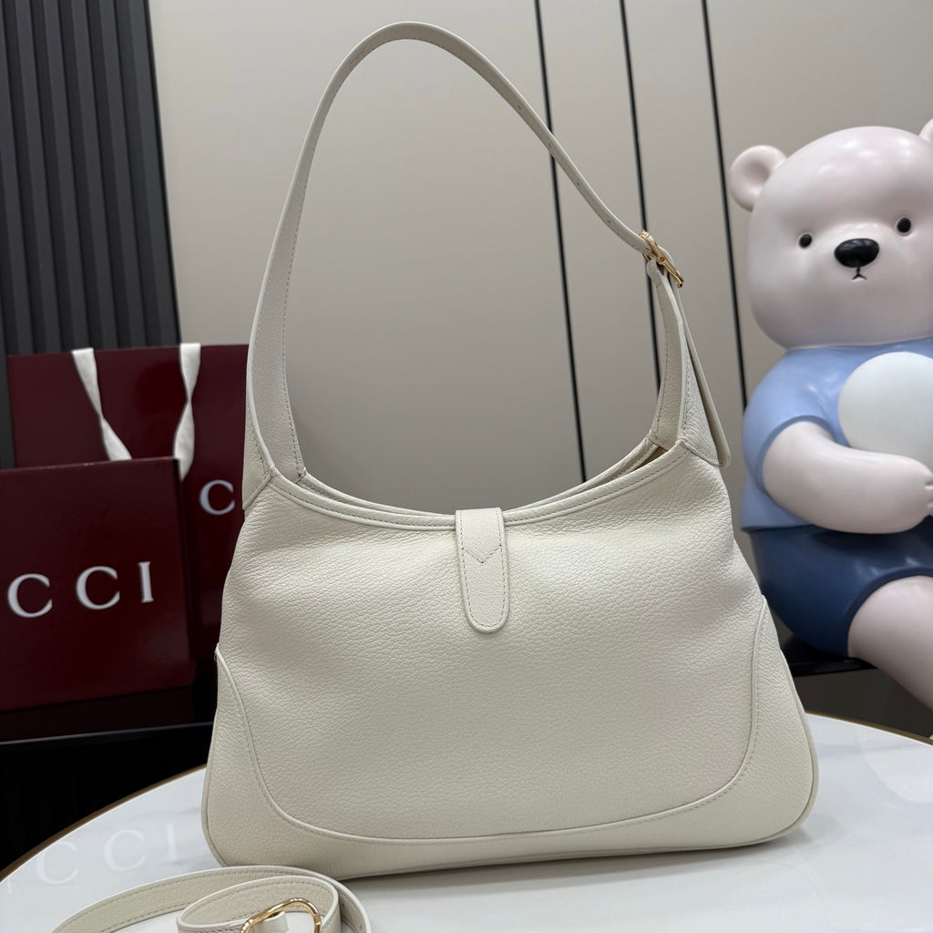White leather hobo bag with gold hardware and rounded top