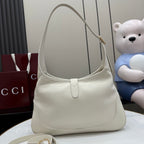 White leather hobo bag with gold hardware and rounded top