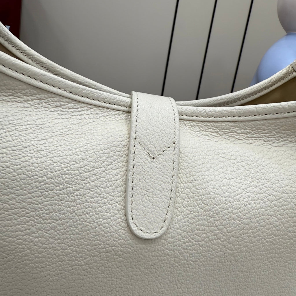 White textured leather bag top with strap and stitched panel