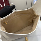 White leather tote interior with beige lining and gold zipper