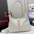 White leather hobo bag with gold clasp and top handle