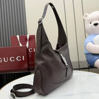 Dark brown leather hobo bag with detachable strap and front zipper detail