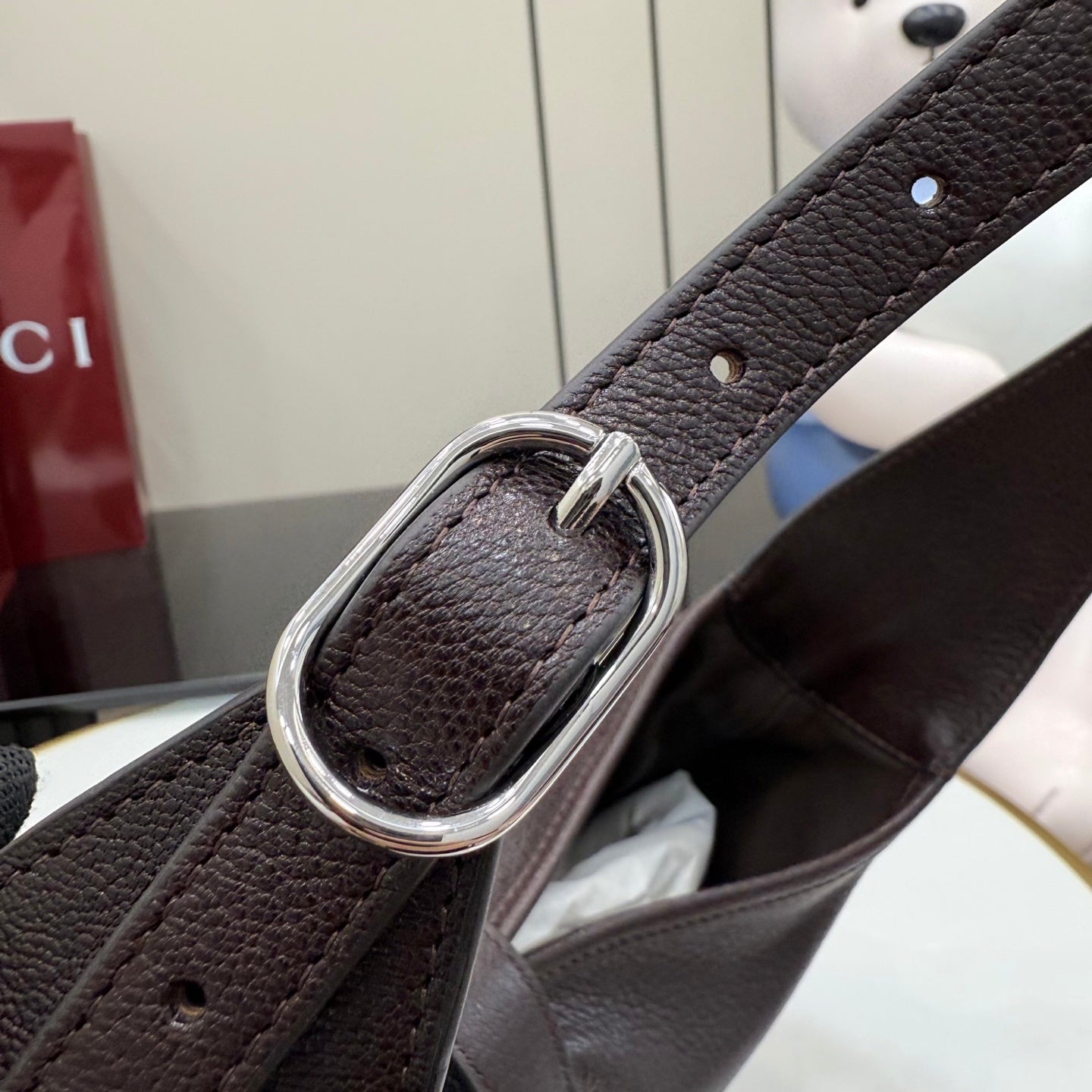 Dark brown leather strap with silver O-ring buckle hardware
