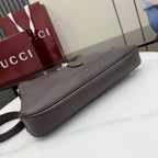 Dark brown leather shoulder bag with top zipper and slim front panel