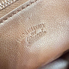 Embossed Made in Italy logo on brown leather bag exterior