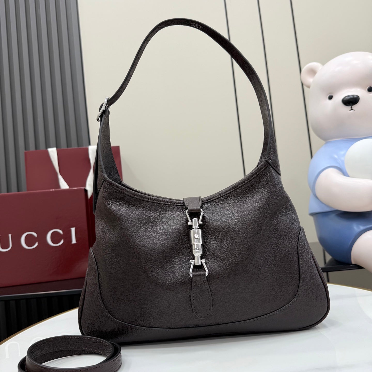 Dark brown leather hobo bag with top handle and front zipper pull